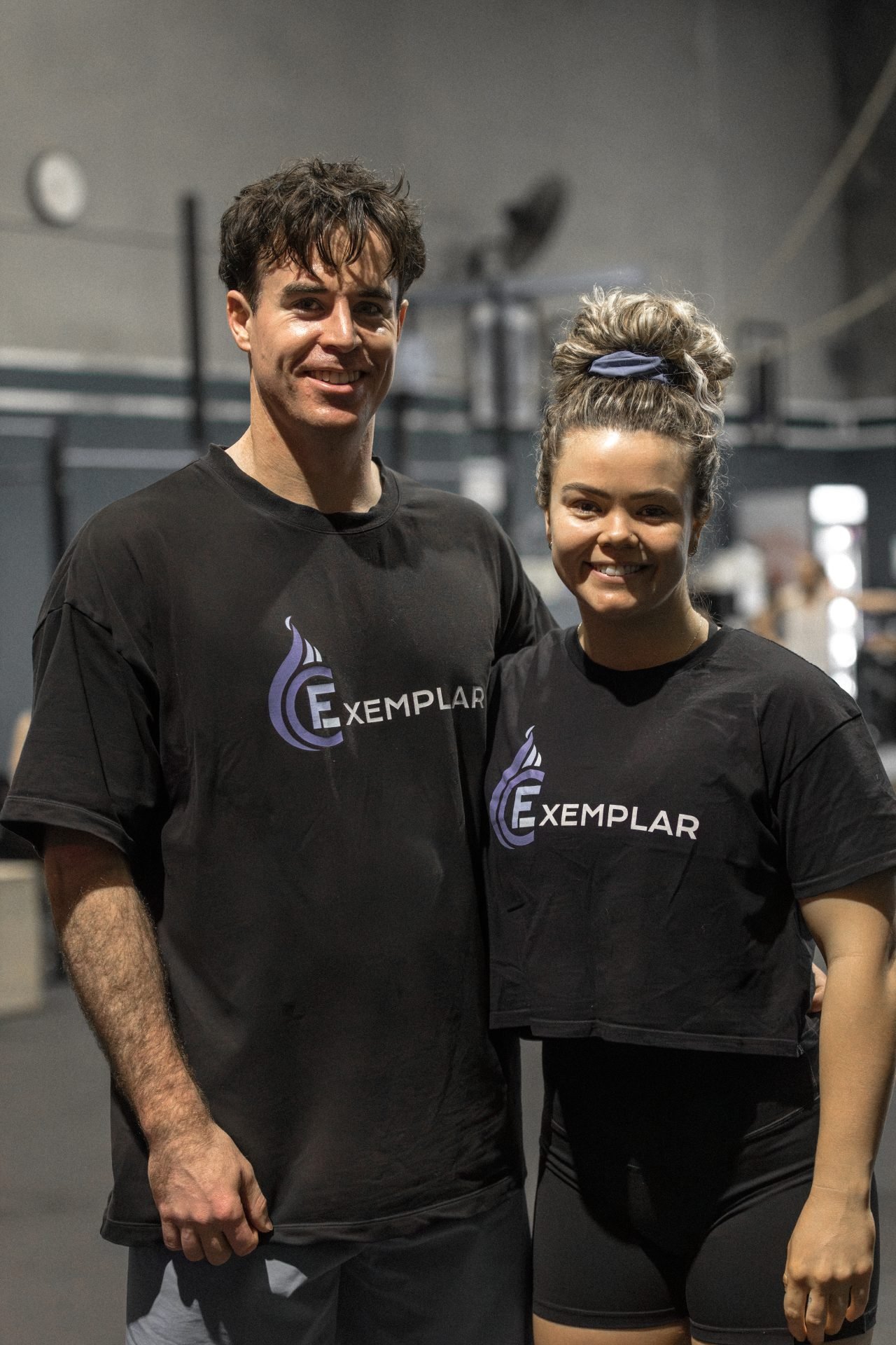 A gym coach on white shirt writing on a whiteboard